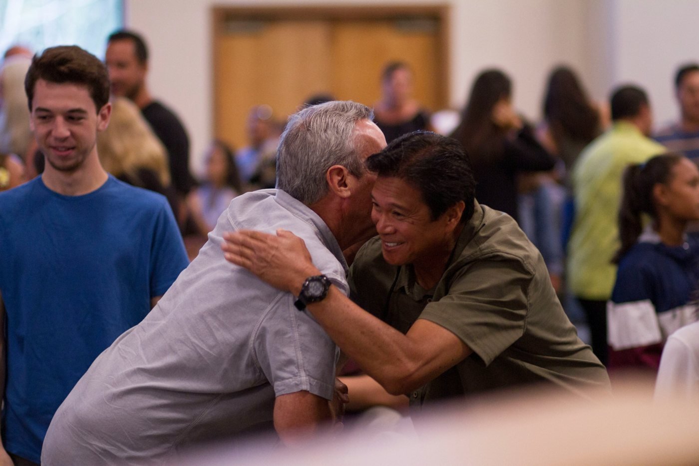 Two members greeting each other with a warm embrace